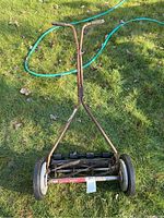 Photo of the full Great States push reel lawn mower showing handlebar, wheels, and blade reel on grass.