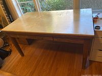 Full view of rectangular solid wood library table with one drawer underneath, showing overall structure and wood grain finish.