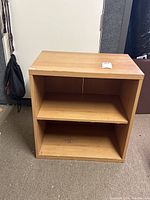 Front view of wooden shelf showing two shelves and open back