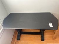 Top view of black wooden sofa table showing rectangular top with surface scratches