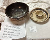 Photo showing two pottery pieces: a large dark glazed bowl and a beige chip-and-dip bowl and tray set with a paper note about the artisan Paul Rice and estimated resale value.