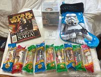 Overall lot showing all items displayed flat: nine vintage PEZ dispensers in original packaging at front, special edition magazine, Funko Pop figure in box, and Star Wars stocking.