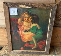 Vintage/Antique art picture showing two children with one kissing the other, framed in custom rustic wood frame.