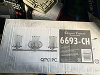 Box for bathroom vanity light fixture with brand and model details visible