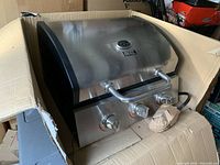 Char-Broil 3 burner propane gas grill cooktop with stainless steel front and three control knobs, new in cardboard box without stand.