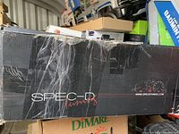 Spec-D Tuning branded black cardboard box with white and red logo, slightly worn.