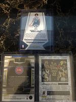 Back of Jarrett Allen card and backs of Cade Cunningham and Deandre Ayton cards
