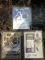Front side of three NFL football rookie cards with autographs and jersey swatch on Curtis Samuel card.