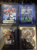 Front view of four NFL rookie cards: Jerry Jeudy purple Shock Rated Prizm, Davis Mills blue Scope Prizm, Jalen Waddle Matrix parallel, and Mac Jones Prizm rookie card.