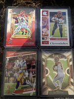 Four Joe Burrow rookie cards front sides showing action shots and design.