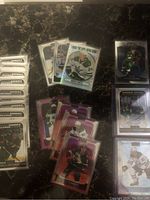 Arrangement of various hockey cards including rookies, silver prizms, sunset prizms, and matte pink prizms showing players from different NHL teams.