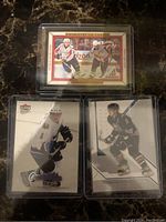 Three hockey cards including Pinnacle Canvas Rookie, Fleer Ultra, and SP Authentic cards, featuring Alex Ovechkin in Capitals uniform on ice, housed in plastic card holders.