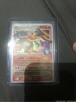 Charizard foil card displayed inside protective plastic sleeve, with holographic foiling visible on the card.