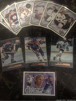 Top view of all 10 Wayne Gretzky hockey cards laid out on dark surface showing front details and images.