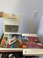 Three French art books featuring Les Fauves and Piet Mondrian, with covers visible and held to show titles and art images.