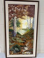Framed oil painting showing forest scene with stream, full front view.