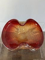 Top-down view showing rich ruby color and silver aventurine bubbles inside the glass bowl.