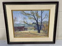 Frontal image of the framed oil painting depicting a rural farmyard with a large tree and two buildings, showing matting and frame.