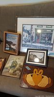 Overview photo of all items in the lot; five pieces of Irish-themed wall art including framed prints and a wooden plaque