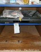 Sony SLV-D380P combo player unit with some plastic coverings on the top, placed on a wooden surface.