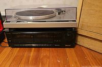 Full view of Technics turntable on top of Sherwood dual cassette deck showing overall condition and placement.