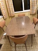 Full view of rectangular kitchen table with Arborite laminate top and 4 matching chairs surrounding it.