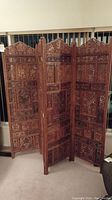 Full view of four-panel folding carved wood screen