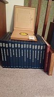 Photo showing 16 blue hardcover box sets with vinyl records and two additional books/sets on the right