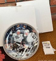 Front of one Wayne Gretzky collector plate showing the hockey scene with Gretzky and scoreboard.