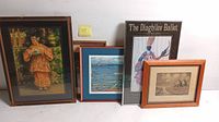 Four framed art prints displayed, including a woman in traditional dress, a waterfront scene, Diaghiley Ballet poster, and vintage boat engraving.