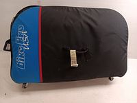 Top view of the black and blue padded bike luggage case with 'Bike Pro USA' logo on blue panel, showing carrying handles and one of the wheels at bottom.