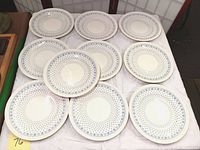 Ten Copeland Spode Centurion dinner plates laid out on a surface showing full set