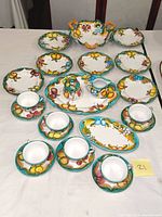 Full view of all items including plates, cups with saucers, covered sugar bowl, creamer, and serving tray on table