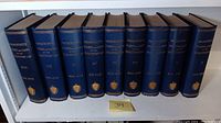 Full view of the 9 volume set of Massachusetts Soldiers and Sailors of the Revolutionary War, showing blue hardcover bindings with gold text on spine.