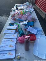 Overview of all items including finger printing art sets, pom-poms, cups, tissue paper, and other party supplies.