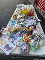Photo showing the full assortment of kids party and educational supplies spread out on a table.