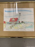 Close-up of the framed pencil signed watercolor picture of Portland Head Light lighthouse by Rob Drowne in 1983.