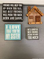 Four wood wall hangings, three with friendship/family quotes and one small house organizer with hooks, displayed from the front.