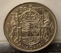 Close-up of the reverse side of the 1941 Canadian 50 cent coin showing the crowned coat of arms with supporters and inscriptions.