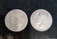 1943 and 1951 Canadian quarters obverse showing King George VI profiles.