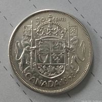 Reverse side of 1958 Canadian silver 50 cent coin showing Canadian coat of arms with two lions holding flags and denomination.