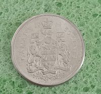 Reverse side showing the Canadian Coat of Arms with date 1964 and 50 cents denomination.