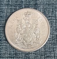 Reverse side of the 1966 Canadian 50 cent silver coin showing the Canadian coat of arms with date and denomination.
