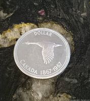 Front side of the coin showing a flying goose and year 1867-1967 commemorating Canadian Centennial.