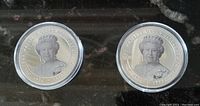 Two souvenir coins featuring Queen Elizabeth II portrait side up, showing 1926-2022 dates and Jubilee text