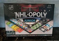 Front of box showing NHL-Opoly Junior branding and game board image.