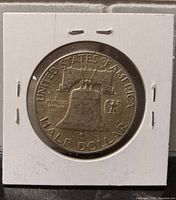 Reverse side of 1949 USA half dollar showing Liberty Bell, inscriptions, and circulated condition.