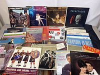 Image shows front covers of various classical music albums including picture of bagpipers, ballet dancers, and orchestral themes.