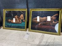 Pair of framed nude paintings, medium size approx 14x18 inches each, shown side by side on floor, with golden frames and glass covers