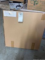 Front view of sealed brown cardboard box containing the Far Infrared Heat Jade Mat.